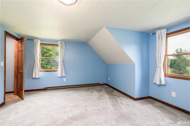 7819 Greenwell Rd, Churubusco, IN 46723 - additional living space with carpet floors, baseboard heating, baseboards, vaulted ceiling, and a textured ceiling