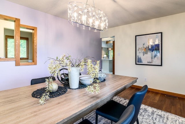 7819 Greenwell Rd, Churubusco, IN 46723 - dining area with wood finished floors, baseboards, and a chandelier