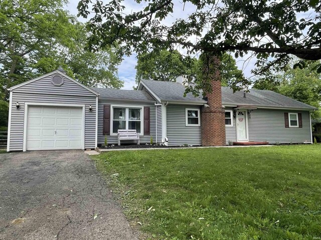 308 S Bittersweet Ln, Muncie, IN 47304 - ranch-style home featuring a chimney, a garage, a front yard, asphalt driveway, and a shingled roof
