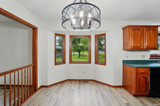611 Big Valley Ct, Huntertown, IN 46748 - unfurnished dining area featuring light wood-type flooring, a chandelier, and baseboards