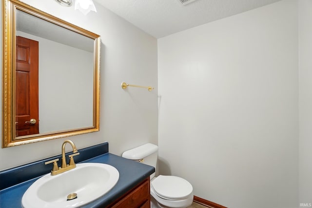 611 Big Valley Ct, Huntertown, IN 46748 - bathroom featuring toilet, vanity, and a textured ceiling