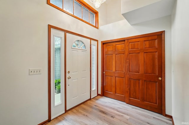 611 Big Valley Ct, Huntertown, IN 46748 - entrance foyer with light wood finished floors, healthy amount of natural light, a high ceiling, and baseboards