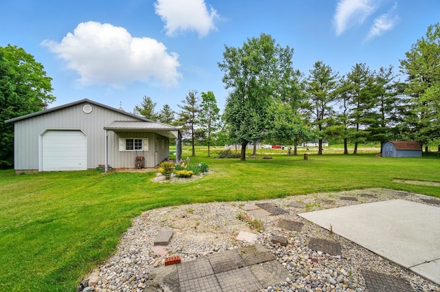 611 Big Valley Ct, Huntertown, IN 46748 - view of grassy yard with an outbuilding and a garage