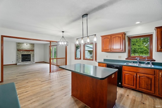 611 Big Valley Ct, Huntertown, IN 46748 - kitchen featuring black dishwasher, a sink, a center island, dark countertops, and light wood-type flooring