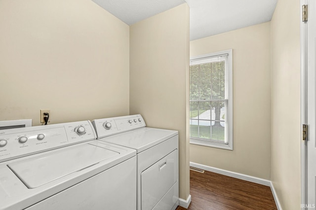 51062 Oak Hollow Ln, South Bend, IN 46628 - laundry room featuring washer and dryer, baseboards, healthy amount of natural light, and dark wood-style floors
