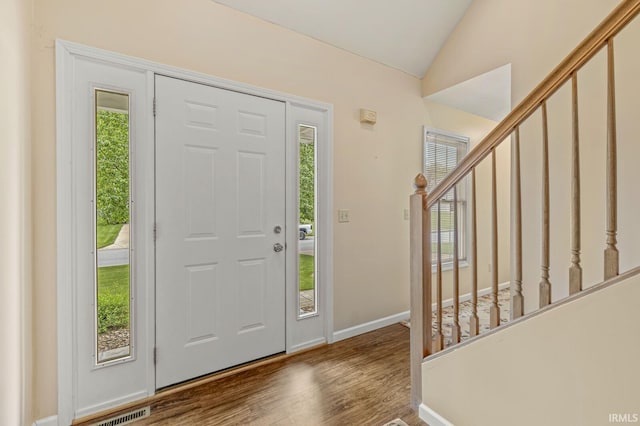 51062 Oak Hollow Ln, South Bend, IN 46628 - foyer featuring vaulted ceiling, wood finished floors, baseboards, and stairway