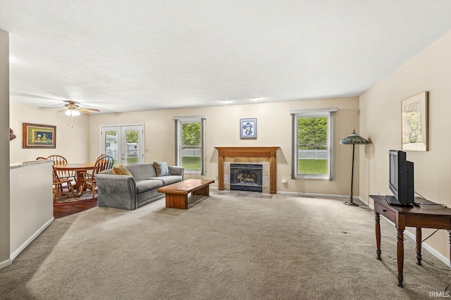 51062 Oak Hollow Ln, South Bend, IN 46628 - living area featuring carpet, a tiled fireplace, baseboards, and ceiling fan