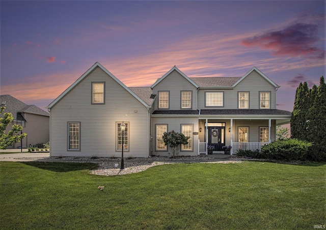 51405 Amesburry Way, Granger, IN 46530 - view of front of house with a porch, a yard, and a shingled roof