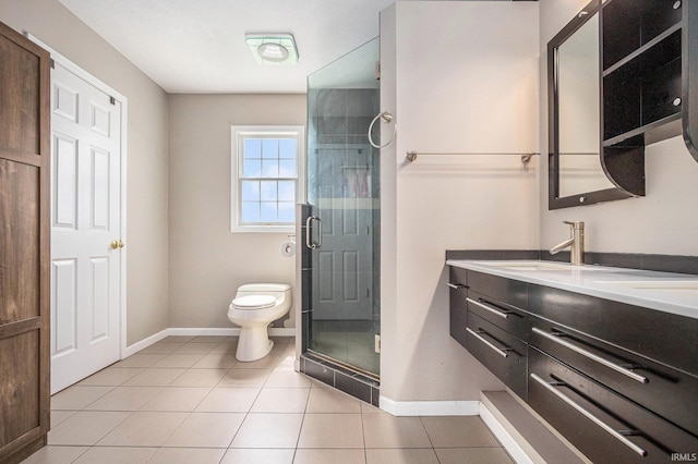 51405 Amesburry Way, Granger, IN 46530 - bathroom with toilet, double vanity, a stall shower, tile patterned floors, and baseboards