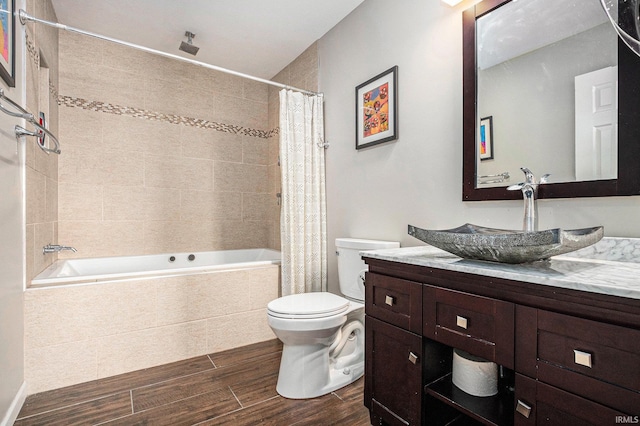 51405 Amesburry Way, Granger, IN 46530 - bathroom with tiled shower / bath, wood finished floors, vanity, and toilet