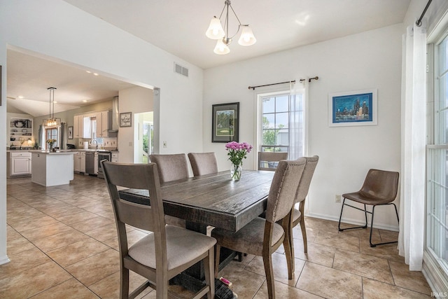 51405 Amesburry Way, Granger, IN 46530 - dining space with a chandelier, light tile patterned floors, and baseboards