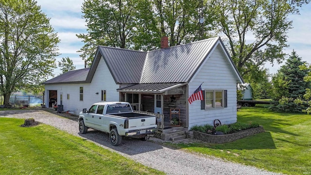 9143 S 900 W, Lafontaine, IN 46940 - view of front of house featuring a chimney, a front lawn, metal roof, and a standing seam roof