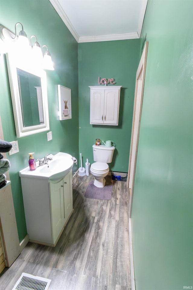 9143 S 900 W, Lafontaine, IN 46940 - bathroom featuring wood finished floors, ornamental molding, vanity, toilet, and baseboards