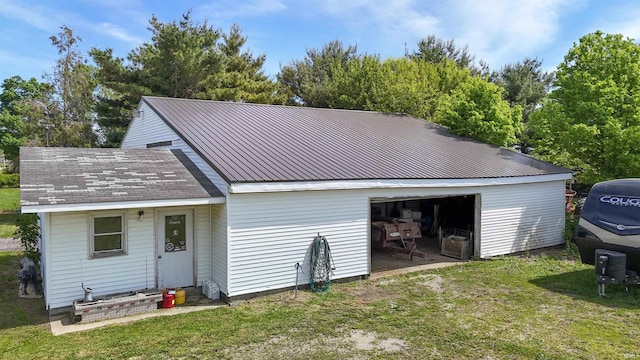 9143 S 900 W, Lafontaine, IN 46940 - back of house featuring a detached garage, a lawn, and metal roof