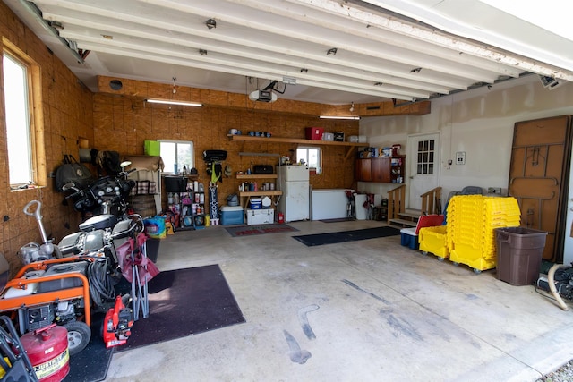 9143 S 900 W, Lafontaine, IN 46940 - garage featuring freestanding refrigerator and a garage door opener