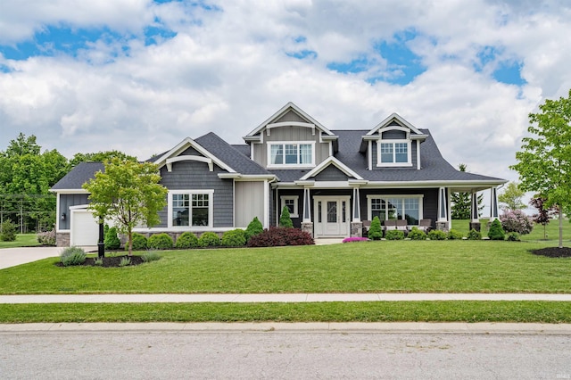13606 Paperbark Trl, Fort Wayne, IN 46814 - craftsman-style house with board and batten siding, stone siding, a front lawn, a garage, and concrete driveway