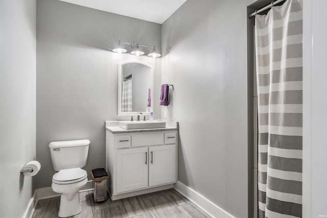 13606 Paperbark Trl, Fort Wayne, IN 46814 - full bathroom featuring toilet, vanity, baseboards, wood finished floors, and a shower with curtain