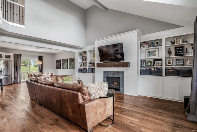13606 Paperbark Trl, Fort Wayne, IN 46814 - living area featuring high vaulted ceiling, dark wood finished floors, a glass covered fireplace, beamed ceiling, and a chandelier
