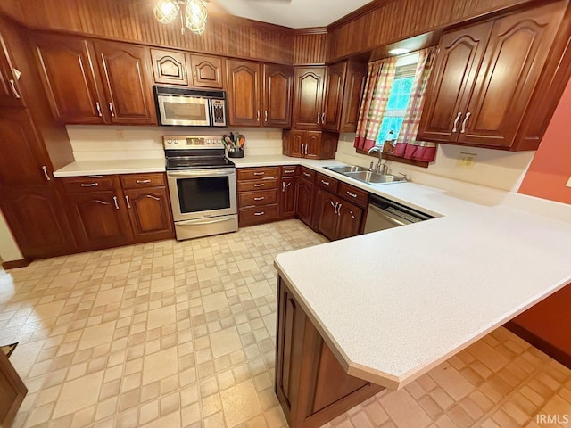 1238 W Wortman Rd, Evansville, IN 47725 - kitchen featuring appliances with stainless steel finishes, a sink, light countertops, a peninsula, and light flooring