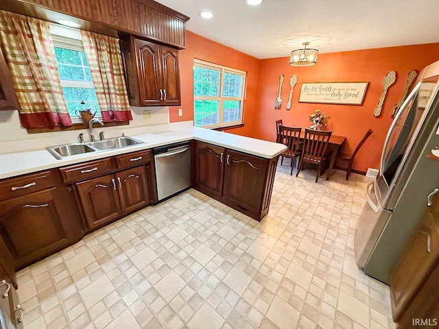 1238 W Wortman Rd, Evansville, IN 47725 - kitchen with appliances with stainless steel finishes, light countertops, a sink, a peninsula, and recessed lighting