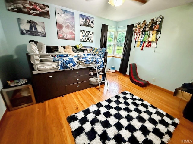 1238 W Wortman Rd, Evansville, IN 47725 - bedroom with wood finished floors, ceiling fan, and baseboards