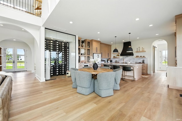 17807 Milazzo Cv, Huntertown, IN 46748 - dining space with arched walkways, plenty of natural light, light wood-style floors, and recessed lighting