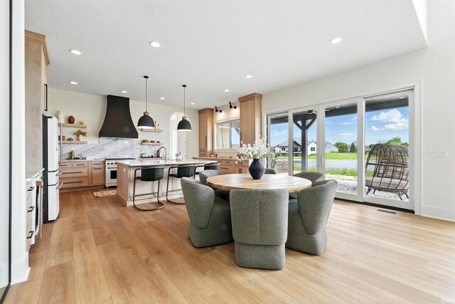 17807 Milazzo Cv, Huntertown, IN 46748 - dining room featuring light wood finished floors, recessed lighting, and a water view