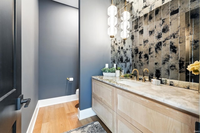 17807 Milazzo Cv, Huntertown, IN 46748 - bathroom with wood finished floors, toilet, vanity, and baseboards