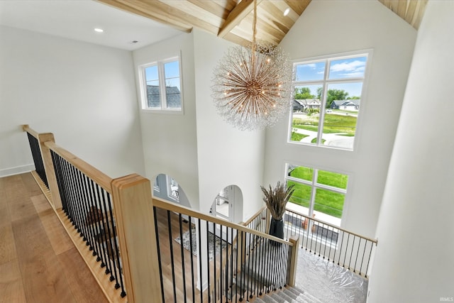17807 Milazzo Cv, Huntertown, IN 46748 - stairway featuring a chandelier, wood finished floors, high vaulted ceiling, beam ceiling, and baseboards
