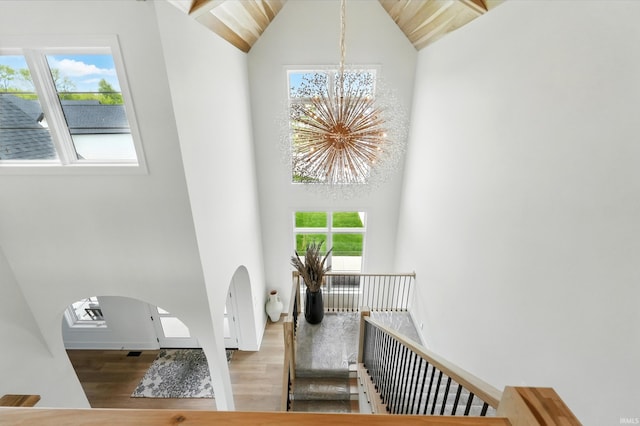 17807 Milazzo Cv, Huntertown, IN 46748 - stairs with a chandelier, wood finished floors, high vaulted ceiling, plenty of natural light, and arched walkways