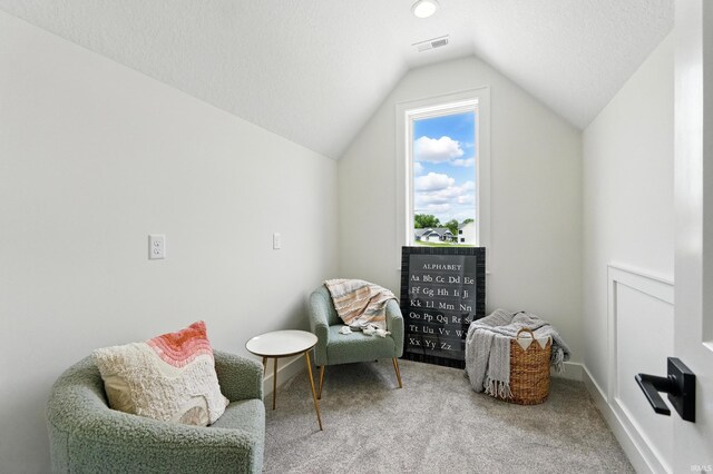 17807 Milazzo Cv, Huntertown, IN 46748 - sitting room with lofted ceiling, carpet floors, a textured ceiling, and baseboards