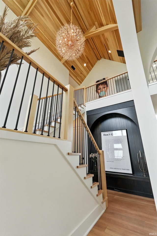17807 Milazzo Cv, Huntertown, IN 46748 - staircase with a chandelier, high vaulted ceiling, wood finished floors, and wood ceiling with exposed beams