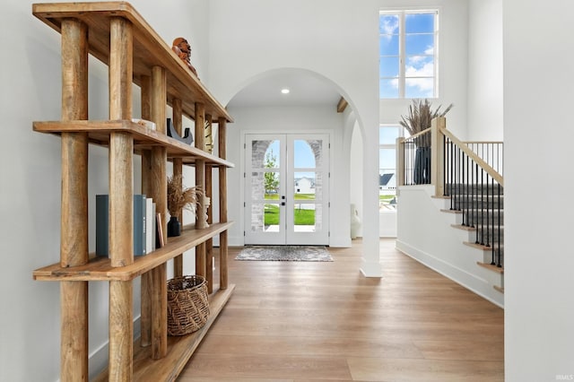 17807 Milazzo Cv, Huntertown, IN 46748 - foyer entrance with arched walkways, french doors, wood finished floors, stairway, and recessed lighting