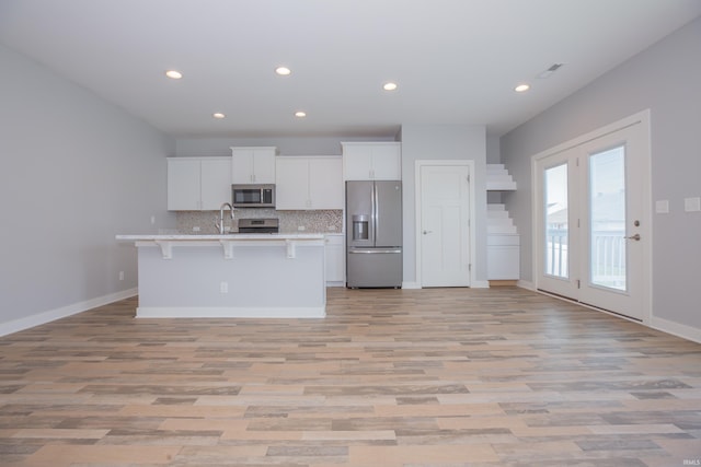 5110 Mustang Dr, Evansville, IN 47715 - kitchen with stainless steel appliances, decorative backsplash, light countertops, white cabinets, and recessed lighting