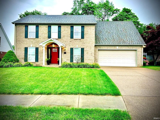 212 Alexandria Dr, Newburgh, IN 47630 - colonial home featuring an attached garage, driveway, a front lawn, and brick siding