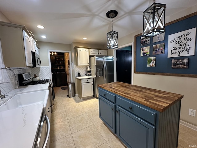 212 Alexandria Dr, Newburgh, IN 47630 - kitchen with appliances with stainless steel finishes, butcher block countertops, decorative backsplash, pendant lighting, and recessed lighting