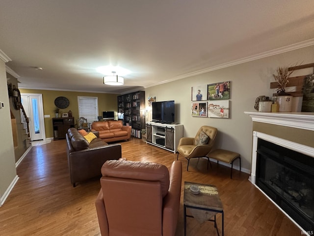 212 Alexandria Dr, Newburgh, IN 47630 - living room with light wood finished floors, ornamental molding, a glass covered fireplace, stairs, and baseboards