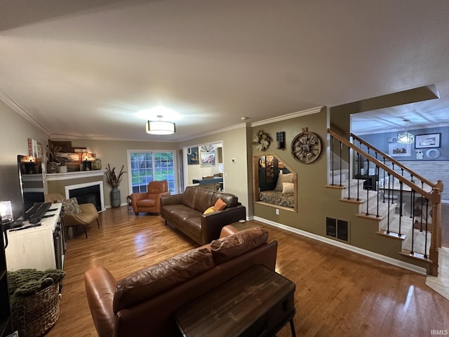 212 Alexandria Dr, Newburgh, IN 47630 - living area featuring ornamental molding, wood finished floors, stairway, a fireplace, and baseboards