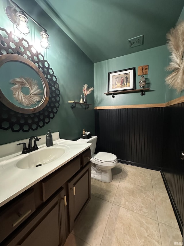 212 Alexandria Dr, Newburgh, IN 47630 - bathroom with toilet, vanity, lofted ceiling, and tile patterned floors