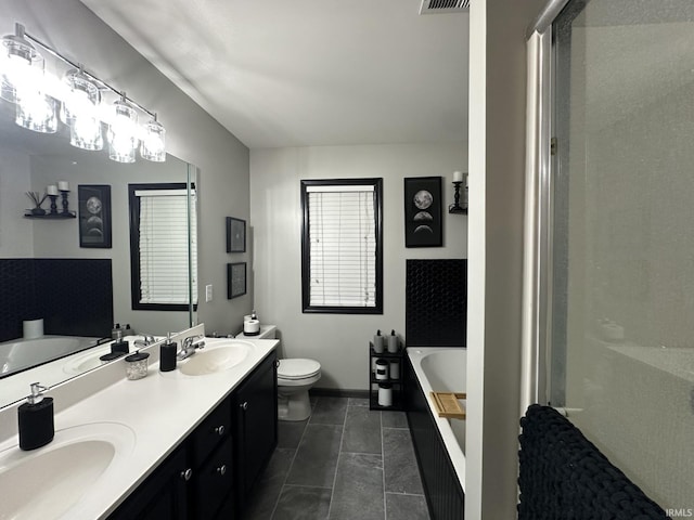 212 Alexandria Dr, Newburgh, IN 47630 - bathroom featuring a garden tub, double vanity, toilet, a shower stall, and baseboards