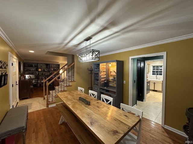 212 Alexandria Dr, Newburgh, IN 47630 - dining room featuring ornamental molding, stairway, light wood finished floors, and a chandelier