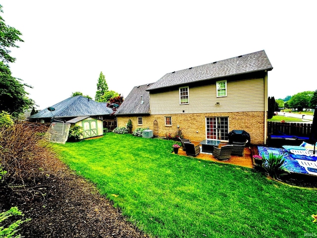 212 Alexandria Dr, Newburgh, IN 47630 - back of house with a patio, brick siding, and an outdoor living space