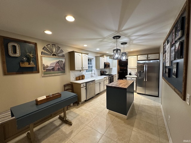 212 Alexandria Dr, Newburgh, IN 47630 - kitchen with stainless steel appliances, butcher block countertops, tasteful backsplash, recessed lighting, and a center island