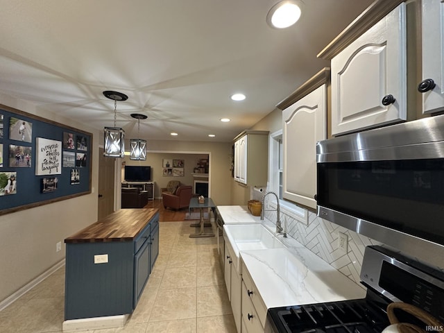212 Alexandria Dr, Newburgh, IN 47630 - kitchen featuring wood counters, appliances with stainless steel finishes, a sink, recessed lighting, and decorative backsplash