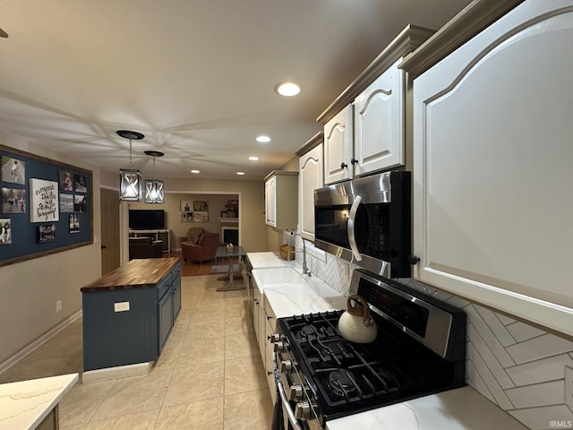 212 Alexandria Dr, Newburgh, IN 47630 - kitchen with appliances with stainless steel finishes, wooden counters, a sink, recessed lighting, and decorative light fixtures