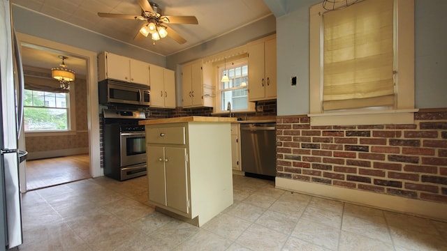 447 Englewood Ct, Fort Wayne, IN 46807 - kitchen with stainless steel appliances, plenty of natural light, a kitchen island, and a ceiling fan
