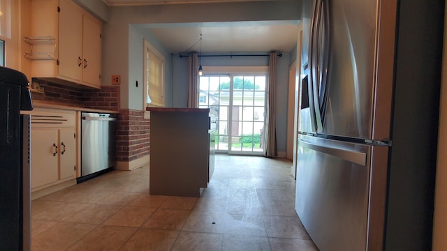 447 Englewood Ct, Fort Wayne, IN 46807 - kitchen featuring appliances with stainless steel finishes, cream cabinets, and backsplash