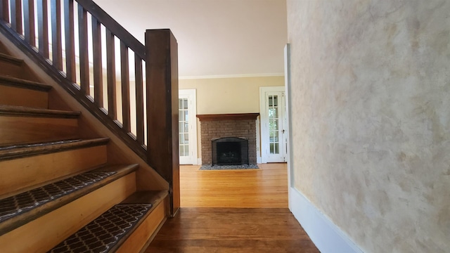 447 Englewood Ct, Fort Wayne, IN 46807 - stairs featuring ornamental molding, wood finished floors, a fireplace, and baseboards