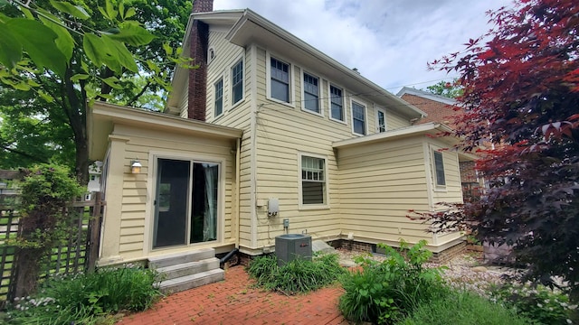 447 Englewood Ct, Fort Wayne, IN 46807 - back of house with entry steps, central air condition unit, a chimney, and a patio area