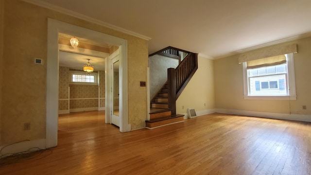 447 Englewood Ct, Fort Wayne, IN 46807 - unfurnished living room featuring wood finished floors, ornamental molding, stairs, and baseboards